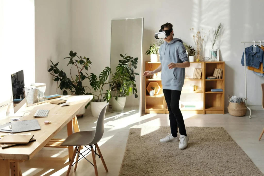 A woman wearing a VR headset in her home office - What is the metaverse?