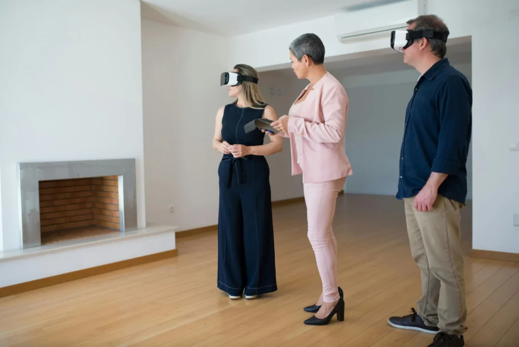 A real estate agent showing a house to people wearing VR headsets