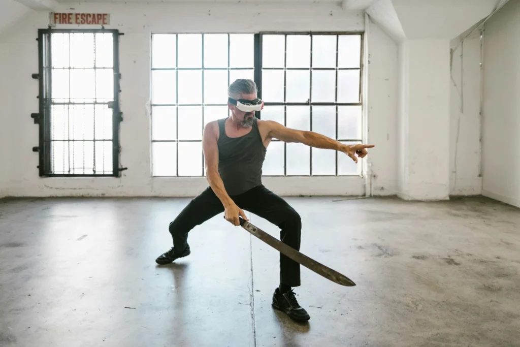 A man training with a sword while wearing a VR headset
