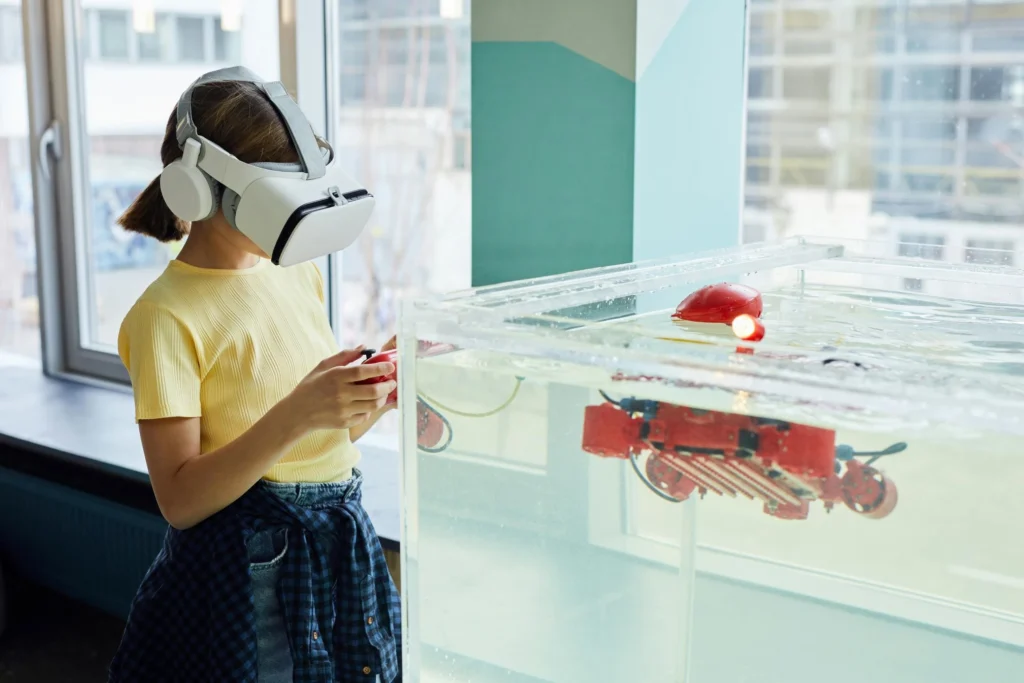 A girl wearing a VR headset and controlling a device