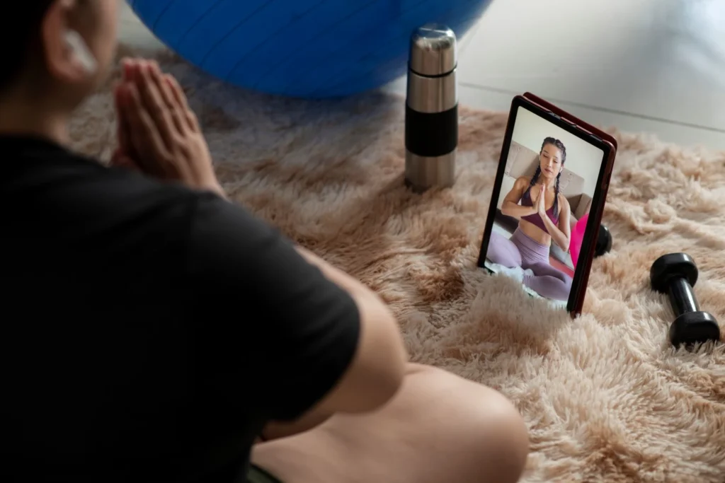 woman following online meditation instructor from meditation apps